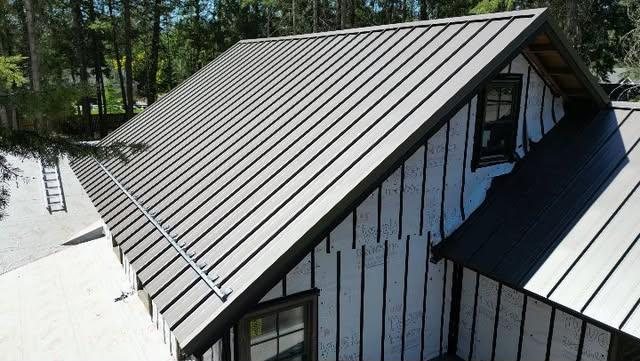 Snow retention bar on a steep standing seam gable