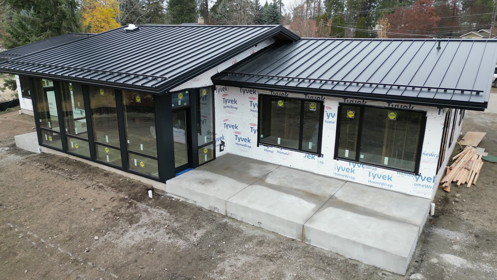 Black standing seam metal roof on a new single-story home